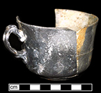 White granite handled cup.  Burned in 1915 fire that destroyed farmstead. Vessel height: 2.25”, Vessel rim diameter: 3.50”, Vessel V-132 - from 18MO609.